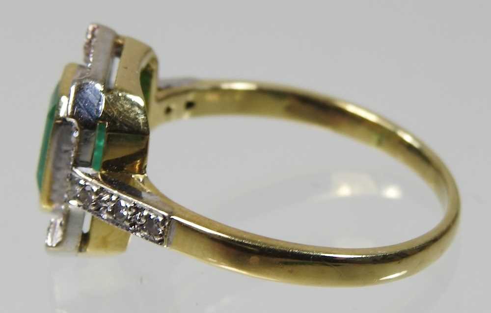 An unmarked emerald and diamond cluster ring, of Art Deco design, with a central baguette cut - Image 2 of 4