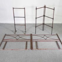 A pair of early 20th century metal single bed heads, together with a folding wooden airer and