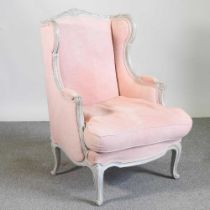 A Louis XVI style white painted and pink upholstered bergere armchair, on cabriole legs