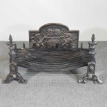 A large cast iron fire grate, 90cm wide, with a pair of fire dogs and a cast iron fireback, with