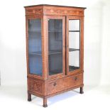 A 19th century Dutch marquetry vitrine, decorated with swags, portrait medallions and festoons,