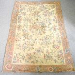 A Kashmiri hand stitched carpet, with all over floral motifs, on a cream ground, 260 x 180cm