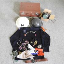 A vintage sea scouts uniform, together with two World War helmets and a gas mask