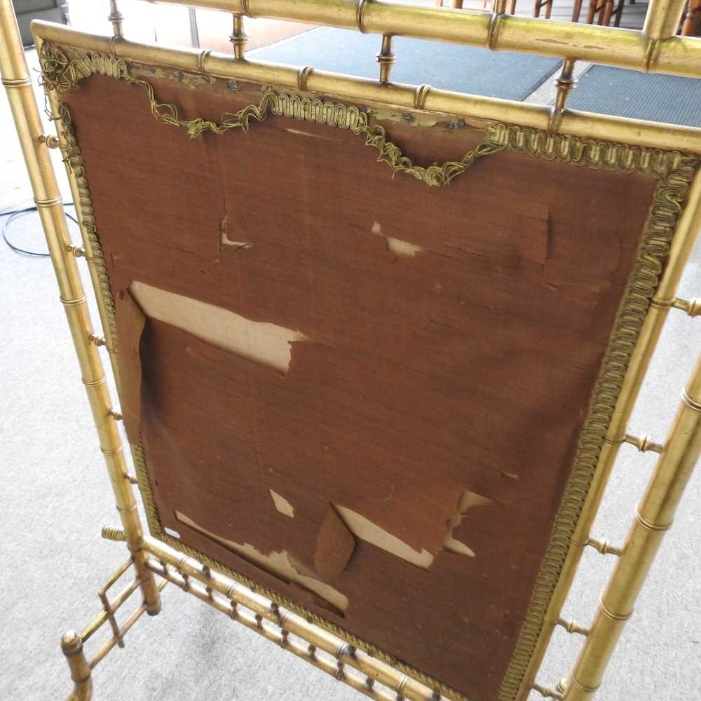 A 19th century simulated bamboo gilt fire screen, inset with a panel painted with a pastoral - Image 2 of 7