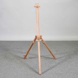 A wooden adjustable artists's easel