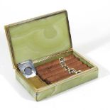 A green onyx cigar box, 18cm wide, containing cigars, a cigar cutter and a Dupont gold plated