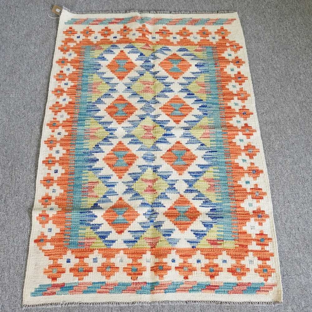 A kelim rug, with two rows of medallions and geometric design, 123 x 80cm