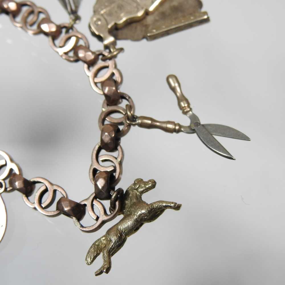 An early 20th century charm bracelet, suspended with a collection of twelve various novelty - Image 8 of 9