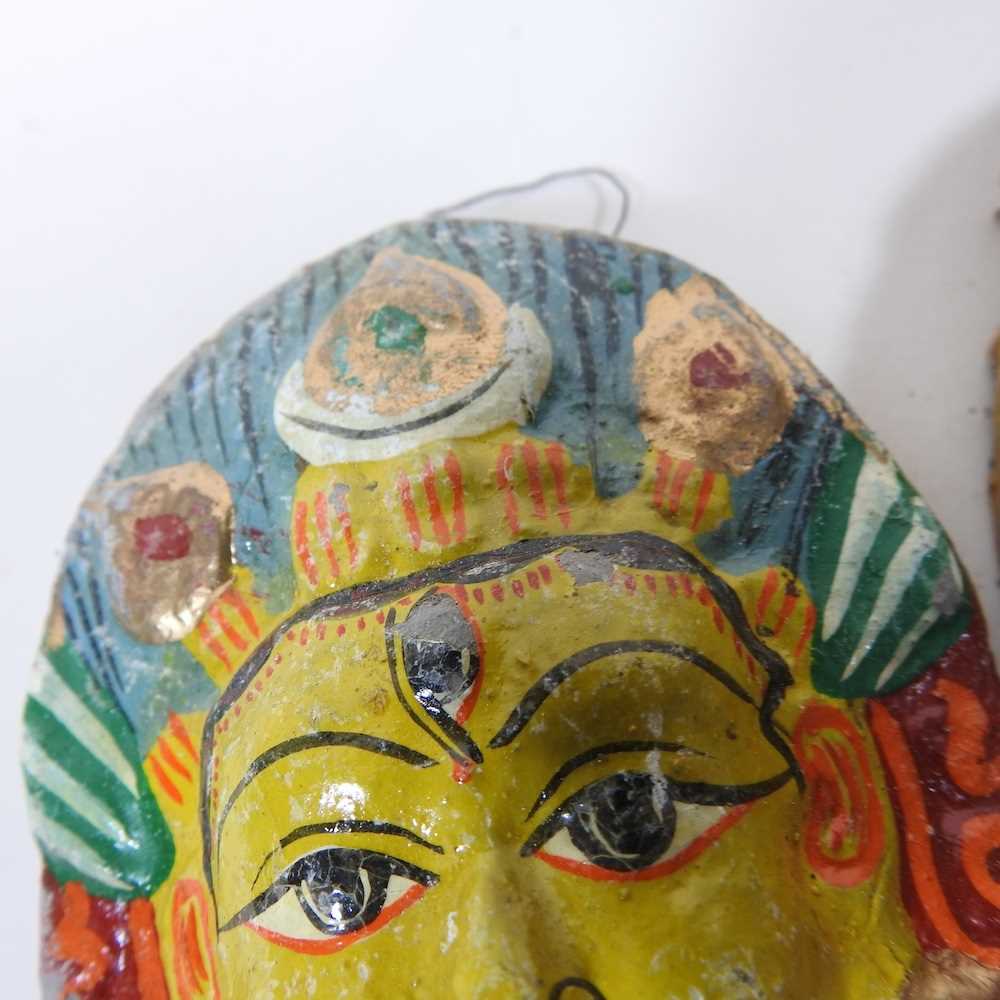 A set of twelve Nepalese painted plaster faces of deities, 7cm high (12) - Image 2 of 6