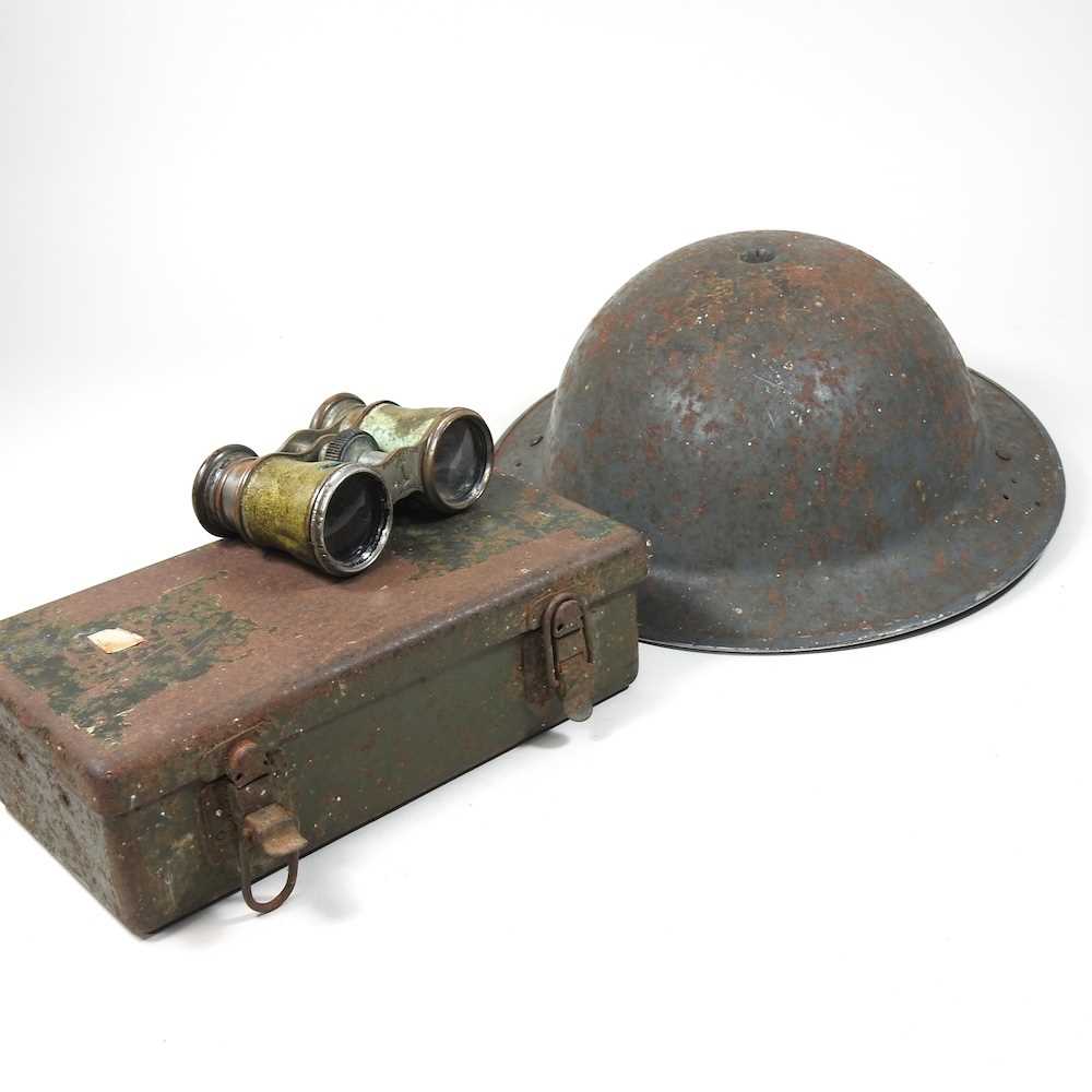 A military metal helmet, together with a war time first aid box and a pair of binoculars