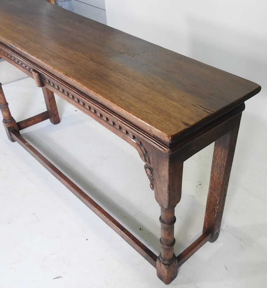 A carved oak console table, 20th century, on turned legs, united by a stretcher 137w x 36d x 71h cm - Image 2 of 3