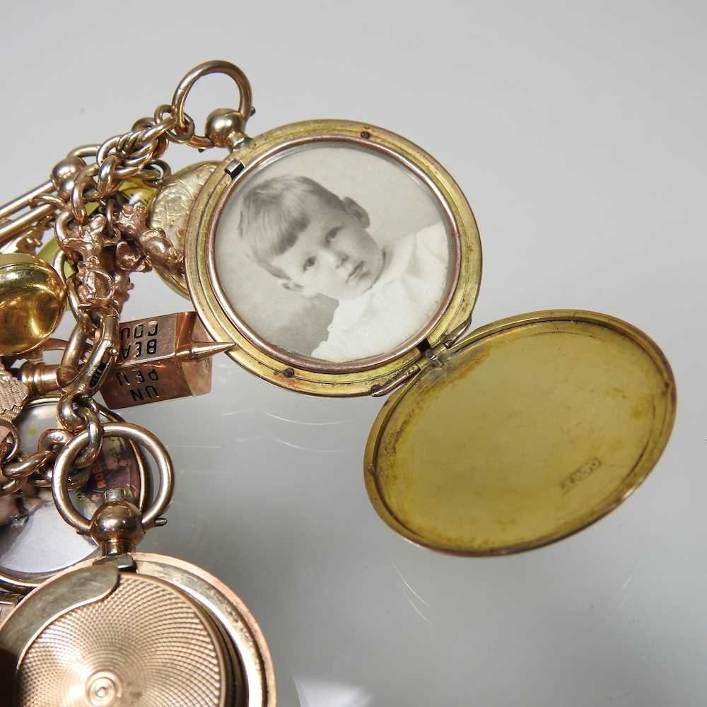 A gold charm bracelet, suspended with twenty-three various novelty charms, to include a sovereign - Image 2 of 12