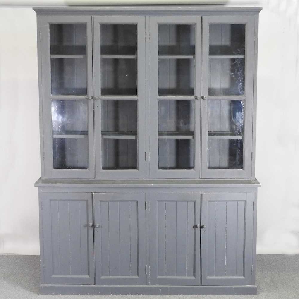 A large dark blue painted dresser, with a glazed upper section and panelled doors below 188w x 43d x