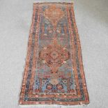 A malayer runner, with flowerhead designs, on a blue ground, 237 x 96cm