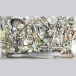 A collection of silver and plated souvenir spoons and other cutlery