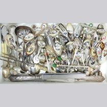 A collection of silver and plated souvenir spoons and other cutlery