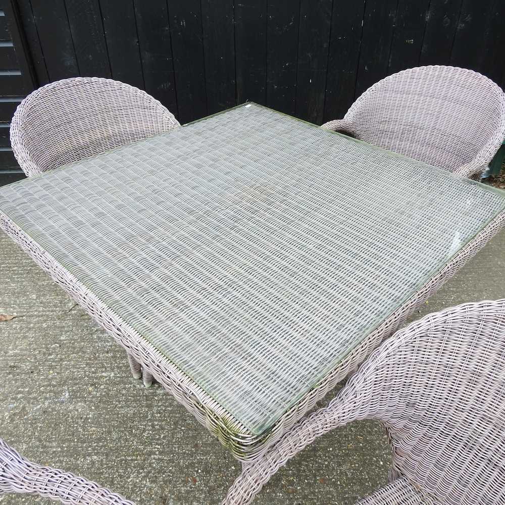 A Bridgman rattan garden table, with a glass top, together with a set of four matching armchairs - Image 4 of 4