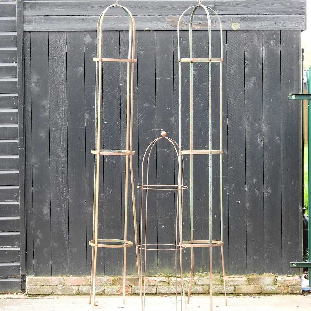 A pair of large iron garden spires, 267cm high, together with another smaller (3)