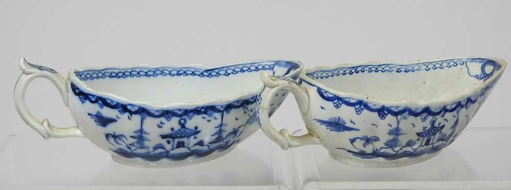A pair of 18th century Staffordshire blue and white sauce boats, circa 1790, each painted with - Image 6 of 10