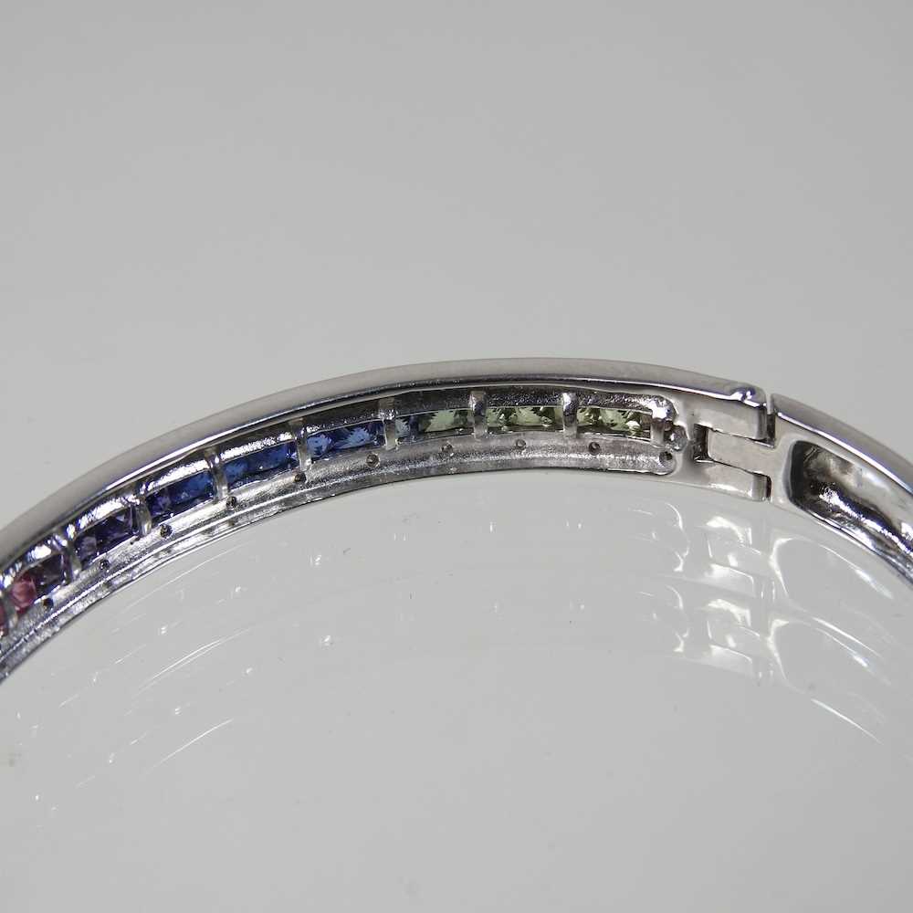 A 9 carat white gold and fancy sapphire bangle, of hinged design, set with a single row of multi - Image 3 of 4