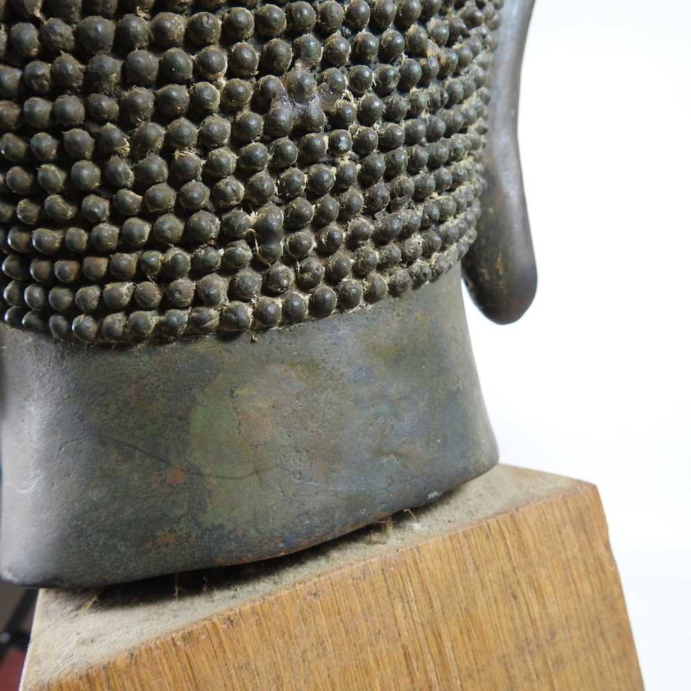 An Eastern bronze life-sized Buddha head, probably 20th century, mounted on a wooden base, 73cm high - Image 10 of 11