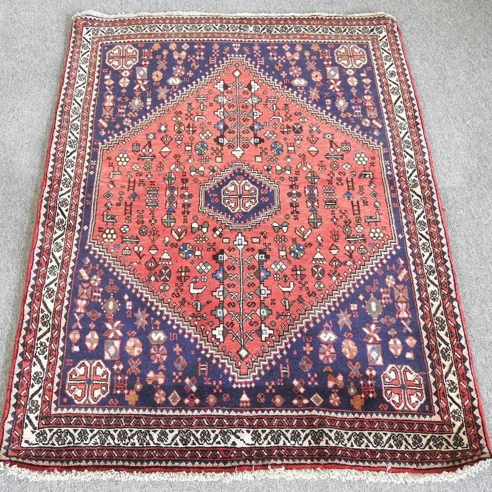 A Persian rug, with a large central medallion, on a blue ground, 146 x 105cm