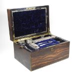 A 19th century patent brass bound coromandel dressing case, the velvet lined interior fitted with