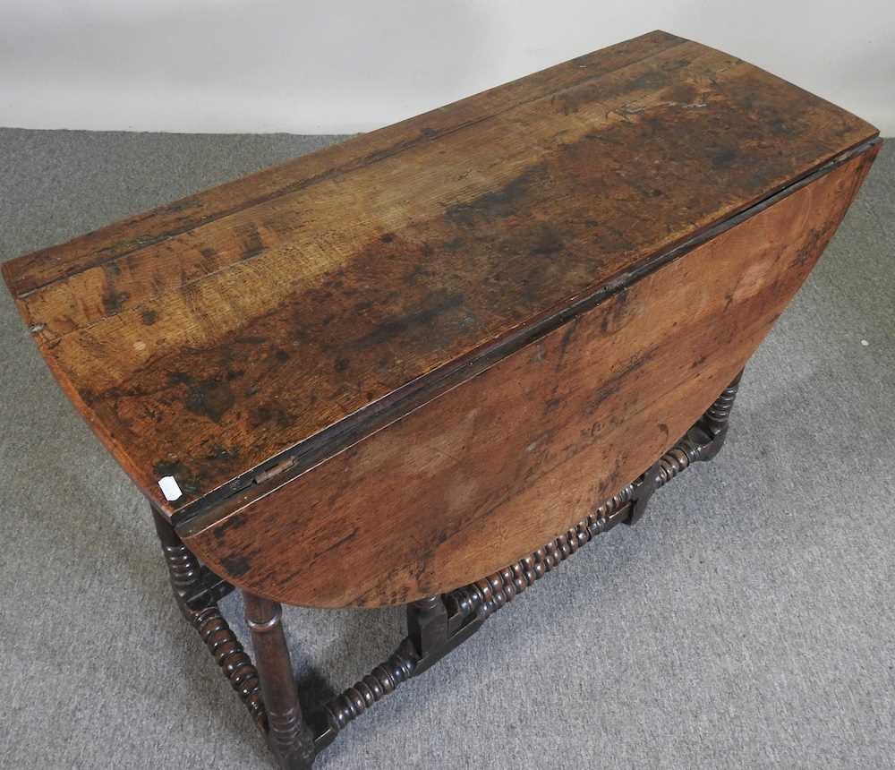 An 18th century oak gateleg table, with a hinged oval top, on bobbin turned legs 108w x 44d x 72h cm - Image 3 of 5