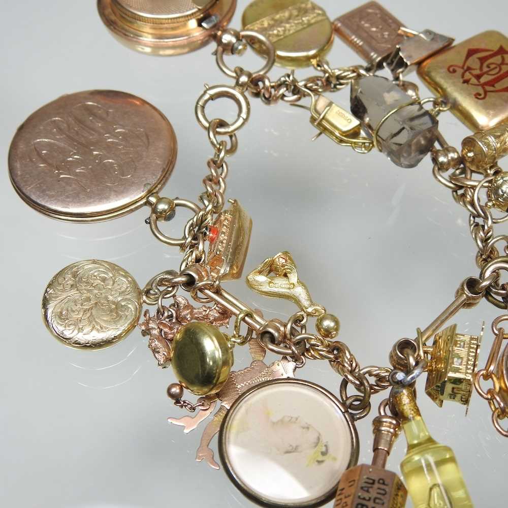 A gold charm bracelet, suspended with twenty-three various novelty charms, to include a sovereign - Image 8 of 12