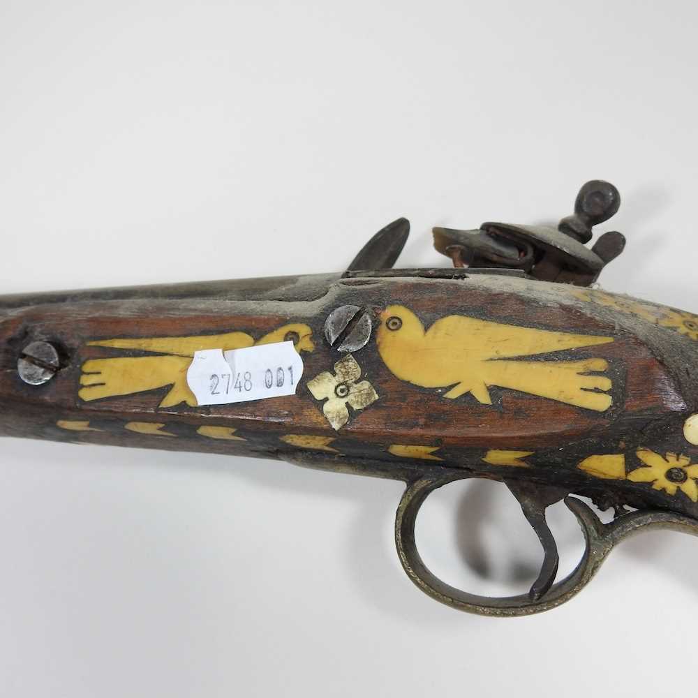 A middle Eastern flintlock pistol, with bone inlay, 40cm long Overall condition is complete. It is - Image 7 of 8