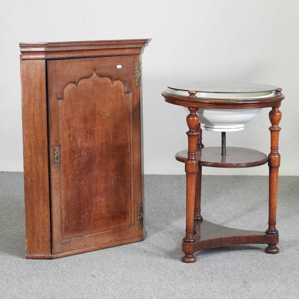 A George III oak hanging corner cabinet, 75cm wide, together with a washstand (2)