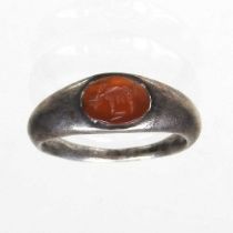 A Roman silver intaglio signet ring, circa 100-300AD, the oval carnelian engraved with a stag,