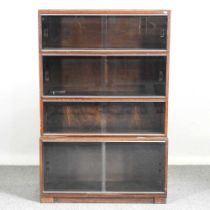 An early 20th century Minty glazed four tier sectional bookcase, enclosed by sliding glazed doors