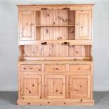 A modern pine dresser, with a boarded back, on a plinth base 152w x 45d x 200h cm