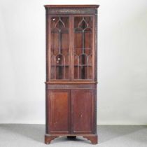 An Edwardian standing corner cabinet, with fret carved decoration 78w x 201h cm