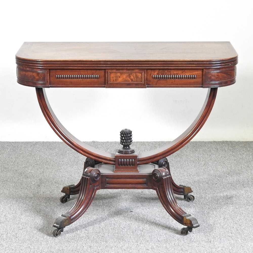 An unusual 19th century mahogany folding tea table, with a hinged rectangular top, on a carved U