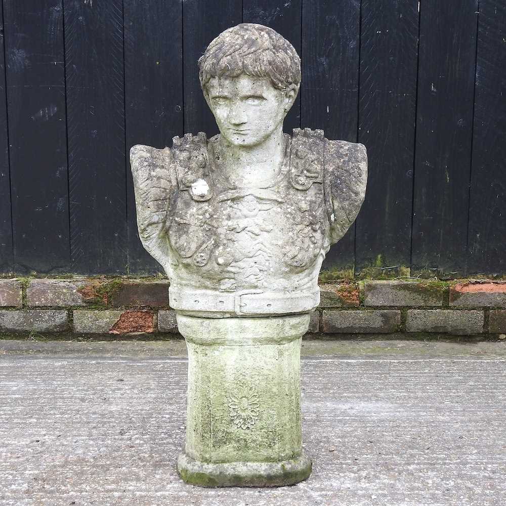 A cast stone garden bust of a Roman Emperor, on a pedestal base, 88cm high overall