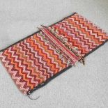 A Persian saddle bag, with zig-zag designs, 136 x 70cm