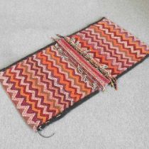 A Persian saddle bag, with zig-zag designs, 136 x 70cm