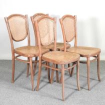 A set of four Thonet bentwood cane seated chairs, some bearing a paper label (4)