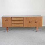 A 1970's laminated sideboard, on tapered legs 182w x 45d x 72h cm