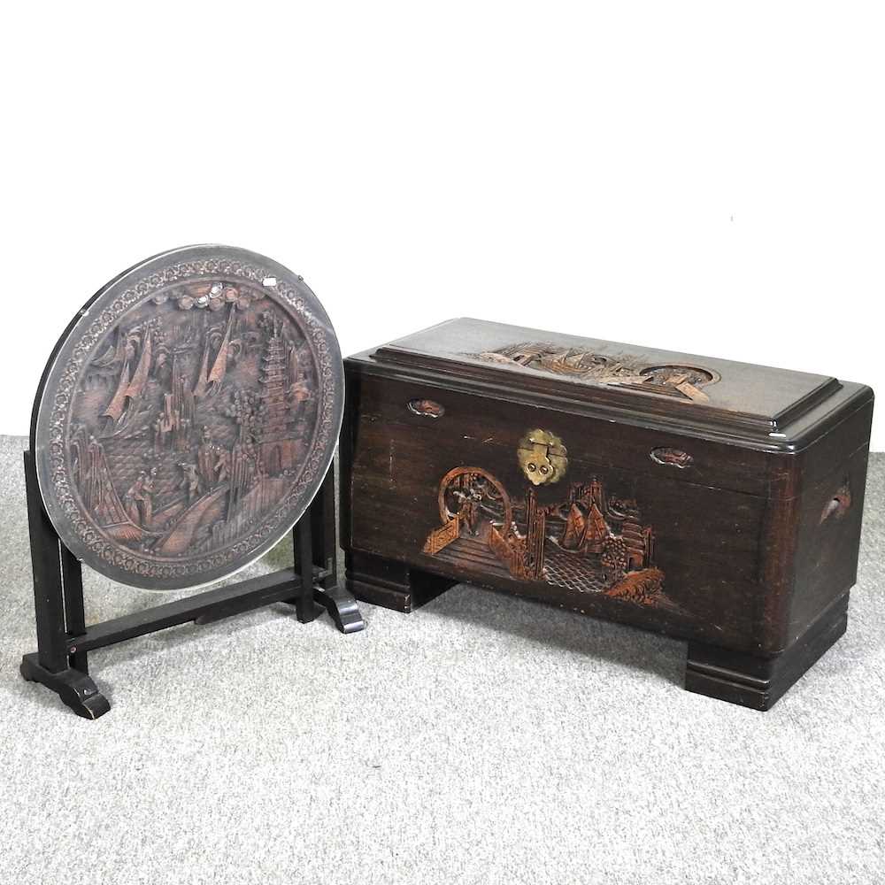 An Eastern carved hardwood blanket box, together with an oriental folding occasional table (2)