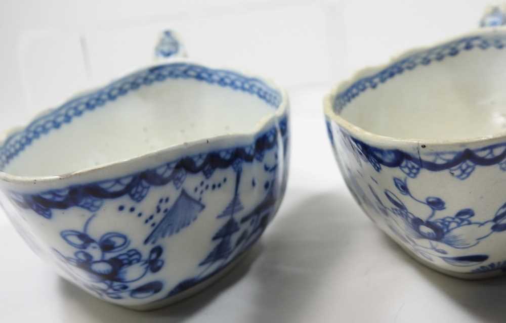 A pair of 18th century Staffordshire blue and white sauce boats, circa 1790, each painted with - Image 2 of 10