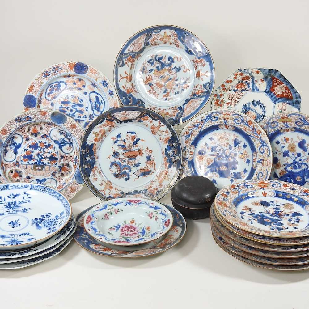A collection of twelve 18th century Imari porcelain plates, each decorated with still life subjects,