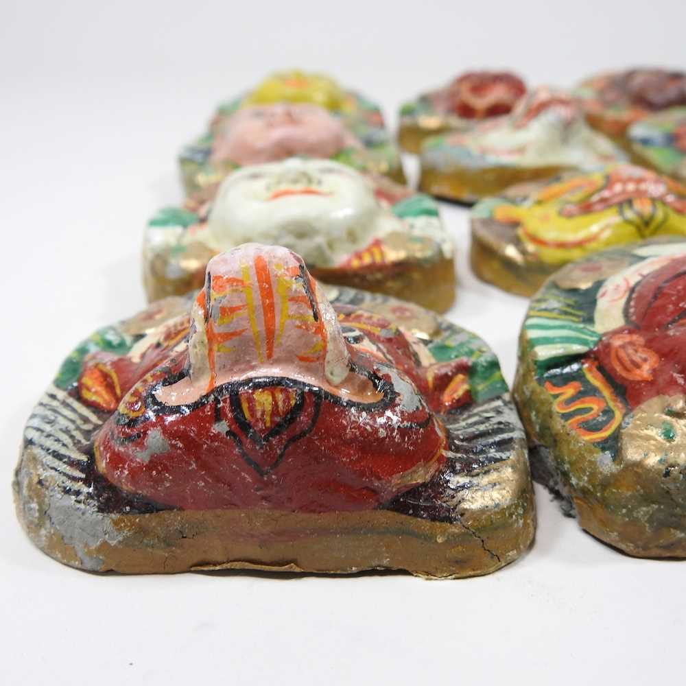 A set of twelve Nepalese painted plaster faces of deities, 7cm high (12) - Image 3 of 6