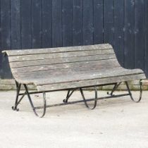 A hardwood garden bench, on metal curved supports 183w x 75d x 77h cm