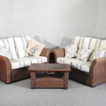 A pair of MGM woven rattan sofas, with cushions, together with two matching side tables (4) 150w x