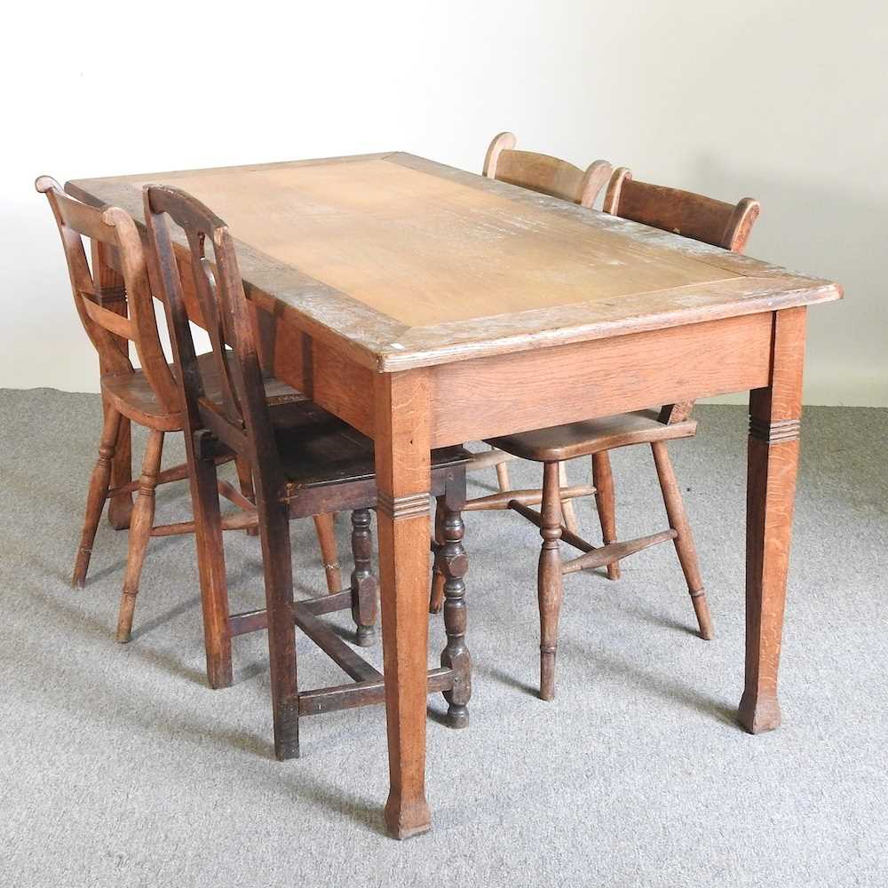 An early 20th century light oak dining table, together with four knife back dining chairs (5) 149w x