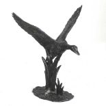 A painted cast metal life size sculpture of a duck flying, 66cm high