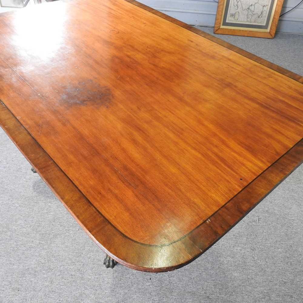 A Regency mahogany and crossbanded dining table, with a hinged top, on a splayed base 144w x 96d x - Image 2 of 4